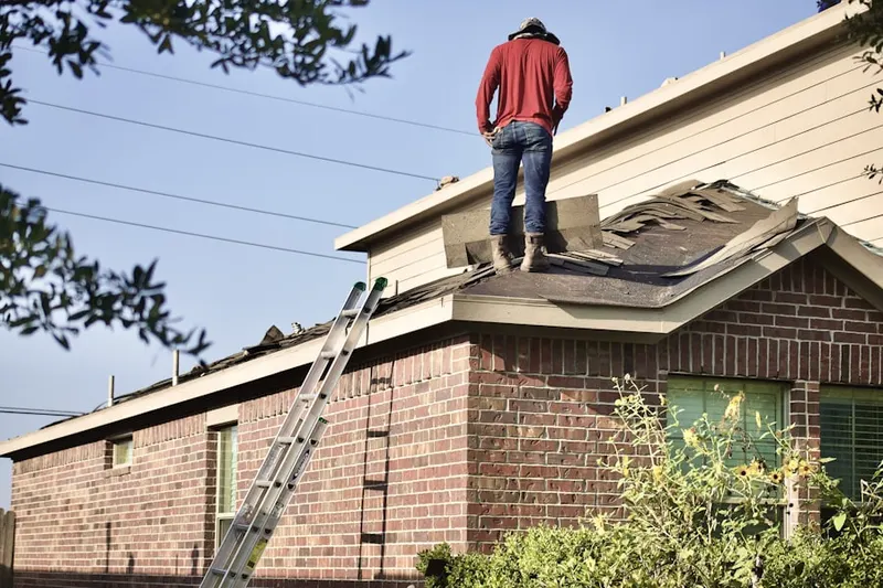 Professional roofer working on a residential roof in Perris